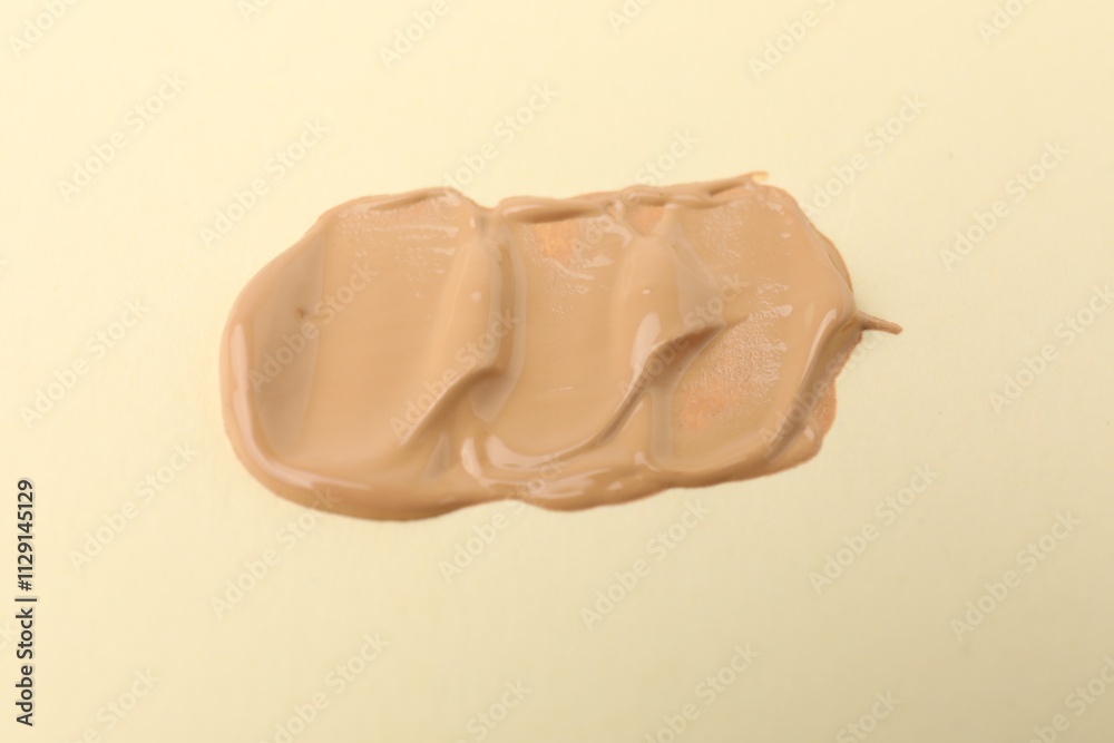 Sample of luxury foundation on beige background Sample of luxury foundation on beige background