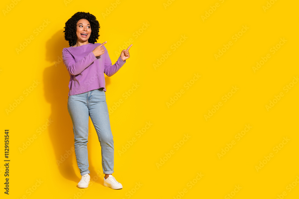 Full body portrait of pretty young girl direct fingers empty space isolated on yellow color background