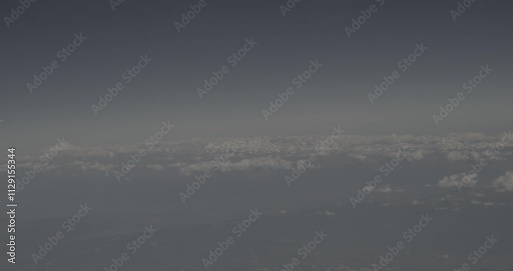 View From Airplane Window On Snow-capped Peaks Of Mount Elbrus And Main Caucasian Range. Travel And Tourism Around World. Elbrus Is Highest Mountain In Europe. Georgian Mountains range. Caucasus View From Airplane Window On Snow-capped Peaks Of Mount Elbrus And Main Caucasian Range. Travel And Tourism Around World. Elbrus Is Highest Mountain In Europe. Georgian Mountains range. Caucasus
