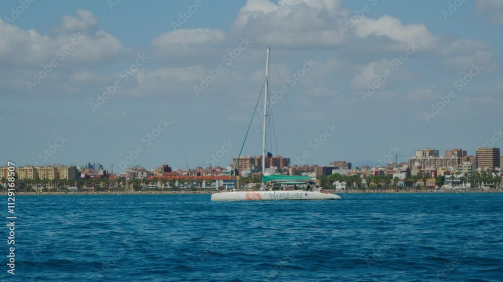 White boat stands anchored in middle of calm blue sea White boat stands anchored in middle of calm blue sea