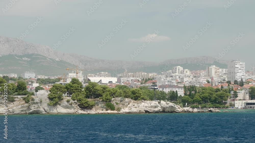 The urban landscape of the Croatian coastal port city of Split on the Adriatic coast on the Marjan Peninsula between the Bay of Kashtela and the Split Canal at the foot of the Mosor Mountains. The urban landscape of the Croatian coastal port city of Split on the Adriatic coast on the Marjan Peninsula between the Bay of Kashtela and the Split Canal at the foot of the Mosor Mountains.