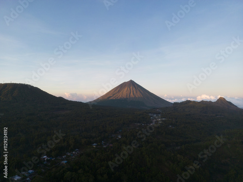 Majestic view of a conical mountain during sunrise. photo