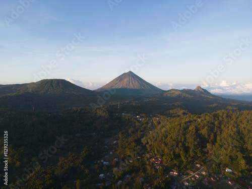 A breathtaking view of a volcano surrounded by lush greenery. photo