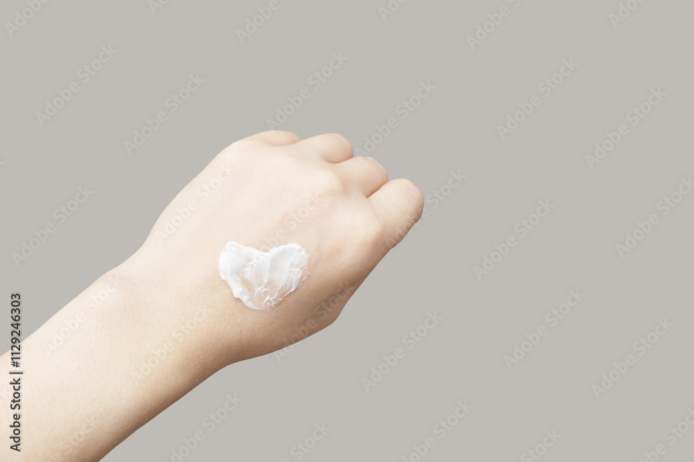 Caucasian female hand with heart shaped cream on neutral background for skincare concept. Caucasian female hand with heart shaped cream on neutral background for skincare concept.