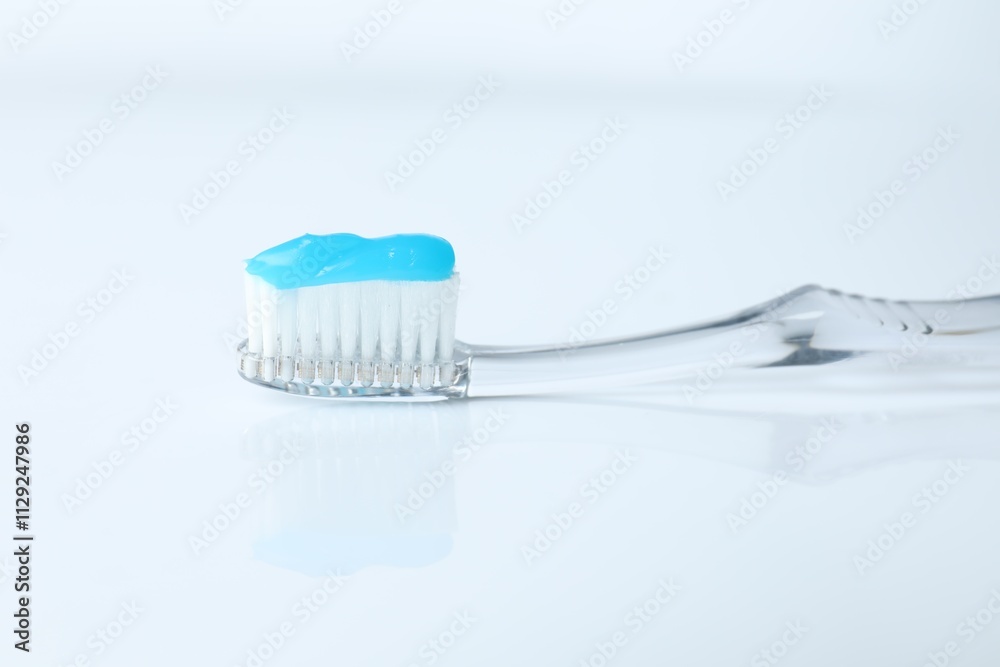 One toothbrush with toothpaste on white background One toothbrush with toothpaste on white background