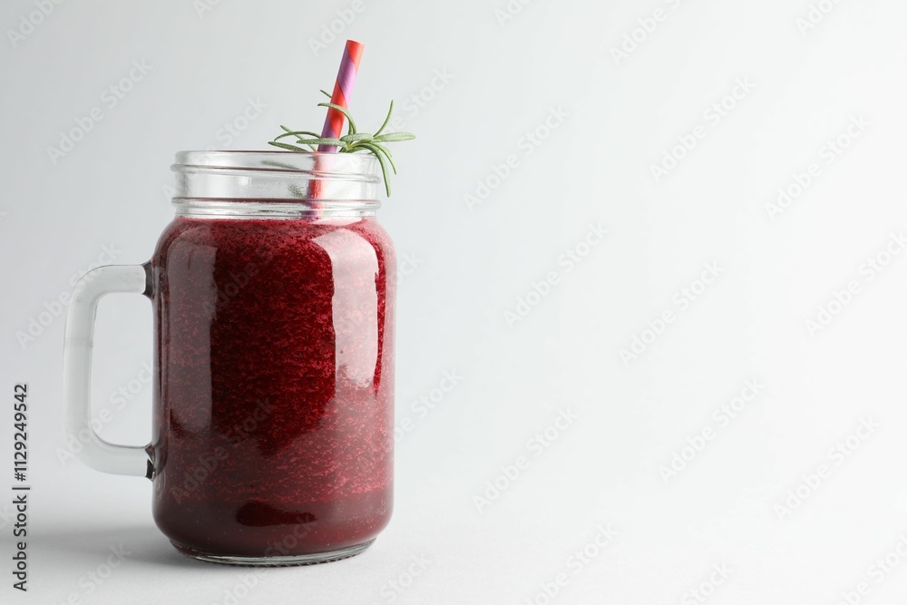 Fresh beetroot smoothie in mason jar on light background, closeup. Space for text Fresh beetroot smoothie in mason jar on light background, closeup. Space for text