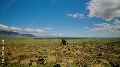 Man hiker climbs hill to enjoy panoramic view from height