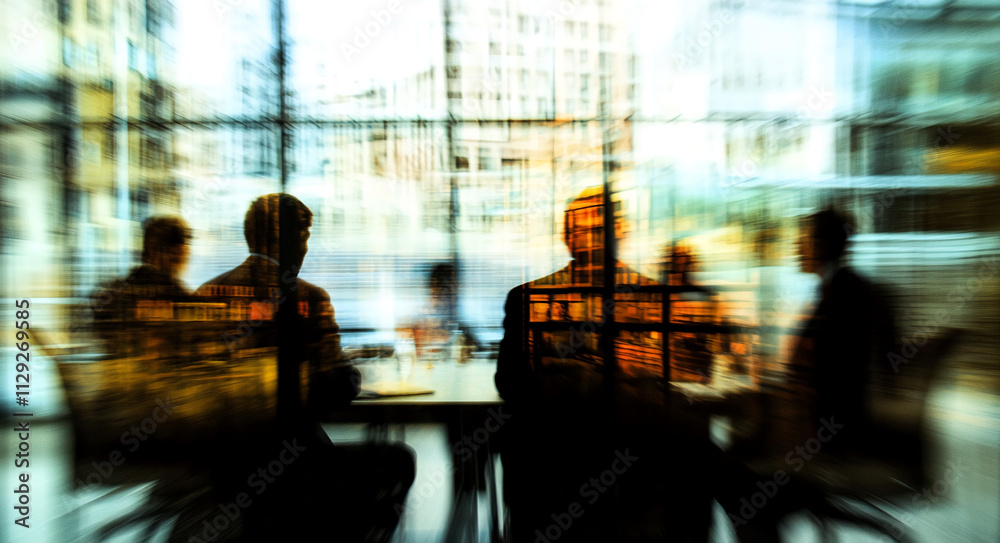 Business meeting with blurred figures in urban office during late afternoon sunlight Business meeting with blurred figures in urban office during late afternoon sunlight