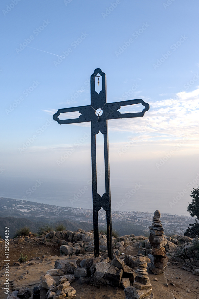 Cruz del Juanar, on a sunny day with small clouds in the sky, with the sunset in the background, Ojen, Marbella, Marbella, Spain Cruz del Juanar, on a sunny day with small clouds in the sky, with the sunset in the background, Ojen, Marbella, Marbella, Spain
