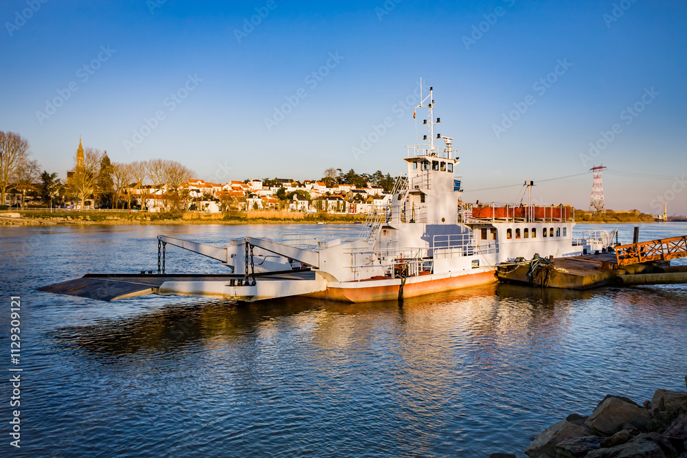 Ferry crossing from Indret shipyards to Indre village in the background, across the Loire river, Ferry crossing from Indret shipyards to Indre village in the background, across the Loire river,