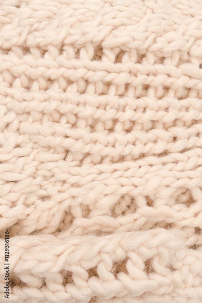 A fragment of beige knitted fabric, knitted from white sheep wool. A fragment of beige knitted fabric, knitted from white sheep wool.