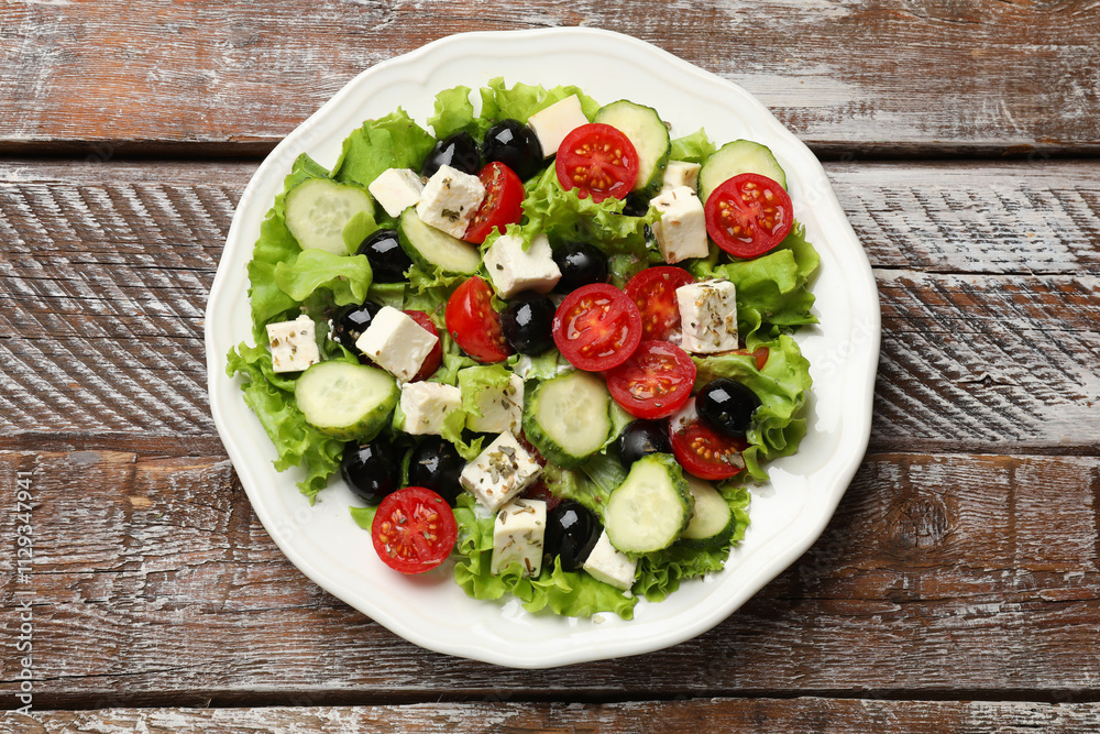 Delicious salad with feta cheese on wooden table, top view Delicious salad with feta cheese on wooden table, top view
