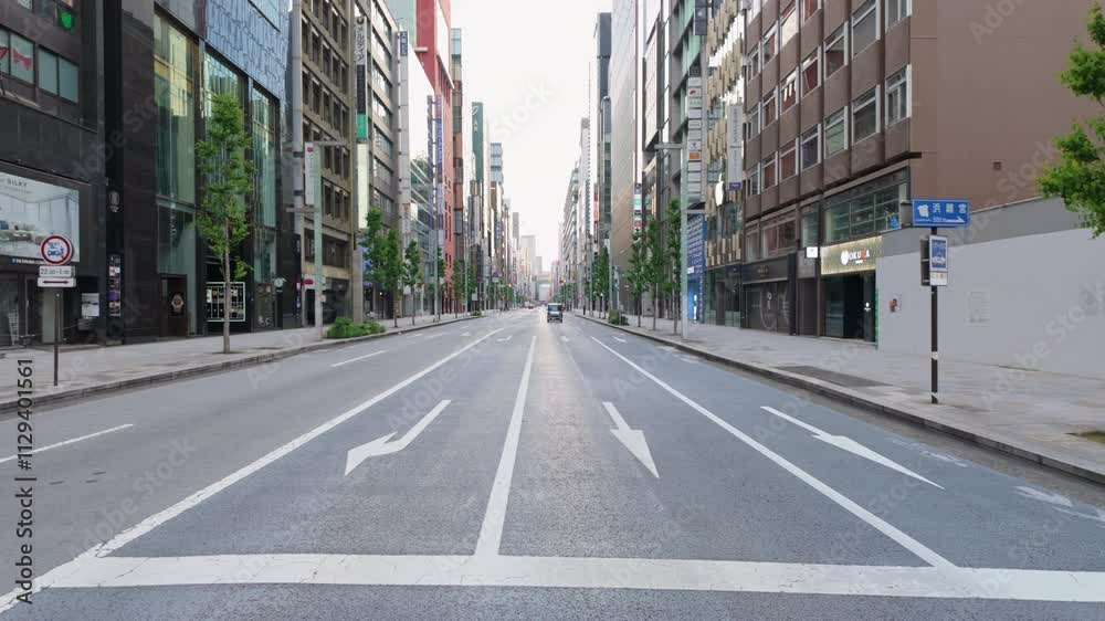 A stunningly empty urban street at dawn showcasing the beauty of a modern cityscape