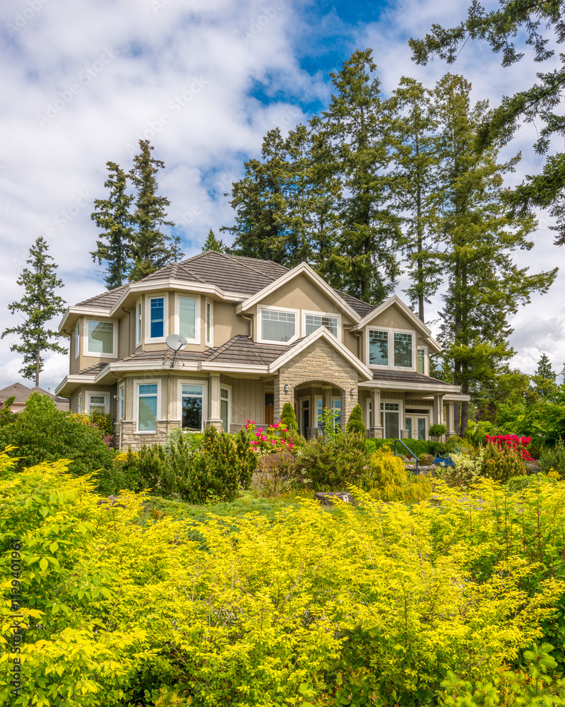 Two story stucco luxury house with nice summer landscape in Vancouver, Canada, North America. Day time on June 2024. Two story stucco luxury house with nice summer landscape in Vancouver, Canada, North America. Day time on June 2024.