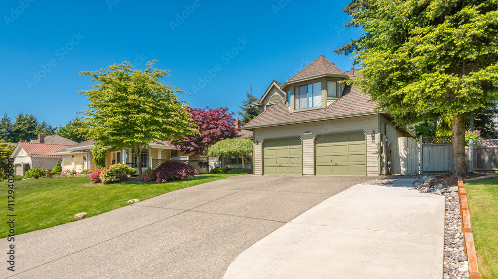Two story stucco luxury house with nice summer landscape in Vancouver, Canada, North America. Day time on June 2024. Two story stucco luxury house with nice summer landscape in Vancouver, Canada, North America. Day time on June 2024.