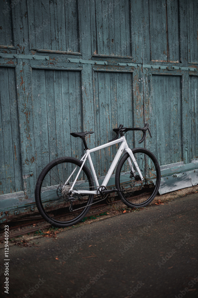 Photo of a bicycle standing on the street near a wooden wall
Photo of a bicycle standing on the street near a wooden wall