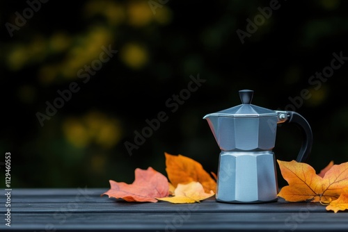 outdoor coffee rituals, outdoor coffee brewing with a moka pot on a picnic table among vibrant autumn leaves creates a cozy setting photo