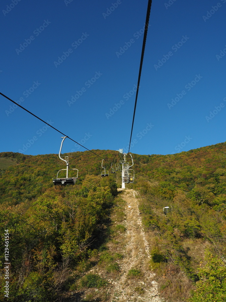 Cable car in the mountains on a background of blue sky.