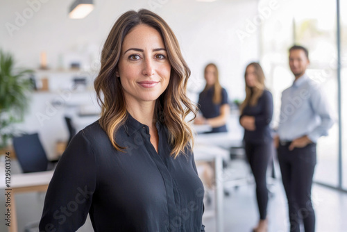 Confident caucasian female leader with business team in modern office setting Free Download Confident caucasian female leader with business team in modern office setting - GFXLoad