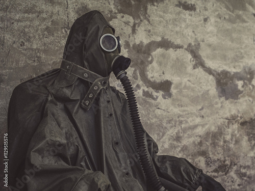 Soldier with vintage military chemical protection hazmat suit and gas mask