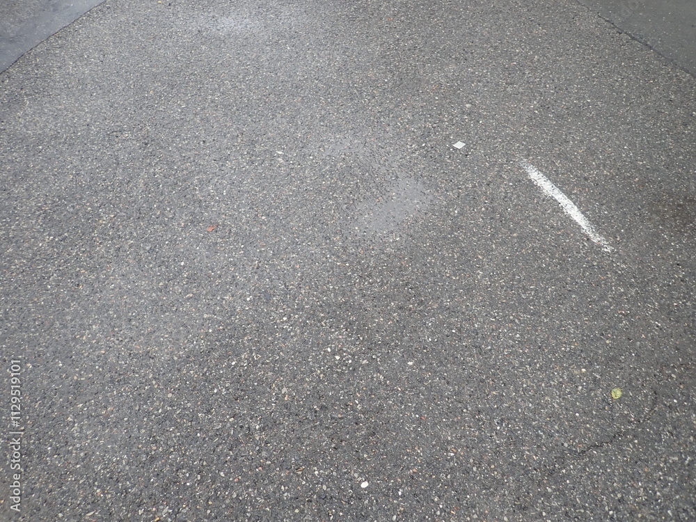 Fototapeta premium asphalt road with broken cracks after rain