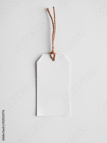 Classic product tag with cord, offering blank space for promotional text. Isolated on white background, ideal for retail use, gifting, or sales during Black Friday or other special occasions.