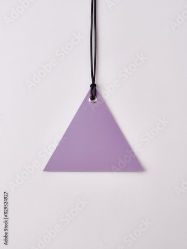 Blank triangular-shaped tag with cord for promotional text. Empty price label hanging on a string. Classic paper tag for business, shopping, or special sale events like Black Friday or Christmas. photo