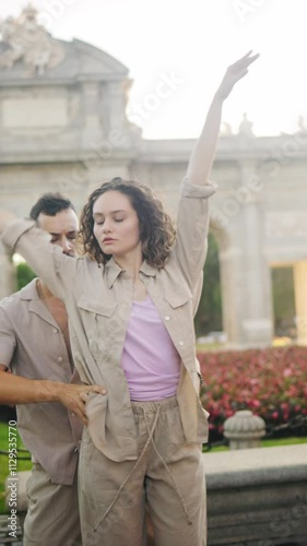 Couple performing swing dance routine in puerta de alcala
