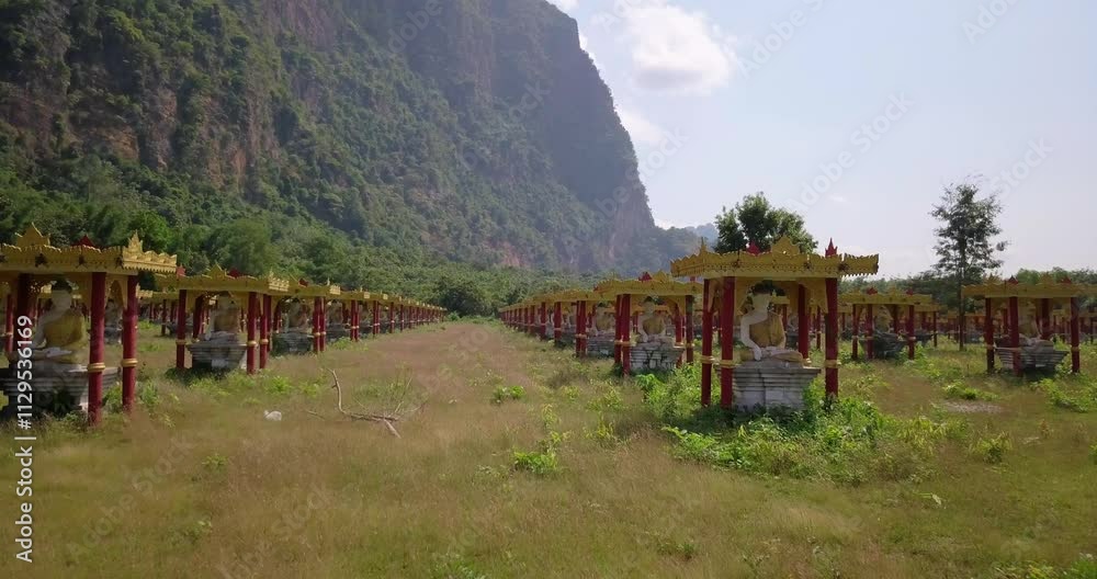 Buddha statues , valley of a thousand buddhas in a field between the mountains, View of pagodas and stupas on the Sagaing Hill in Mandalay, Myanmar ,Burma on a sunny day. Copy space. Buddha statues , valley of a thousand buddhas in a field between the mountains, View of pagodas and stupas on the Sagaing Hill in Mandalay, Myanmar ,Burma on a sunny day. Copy space.
