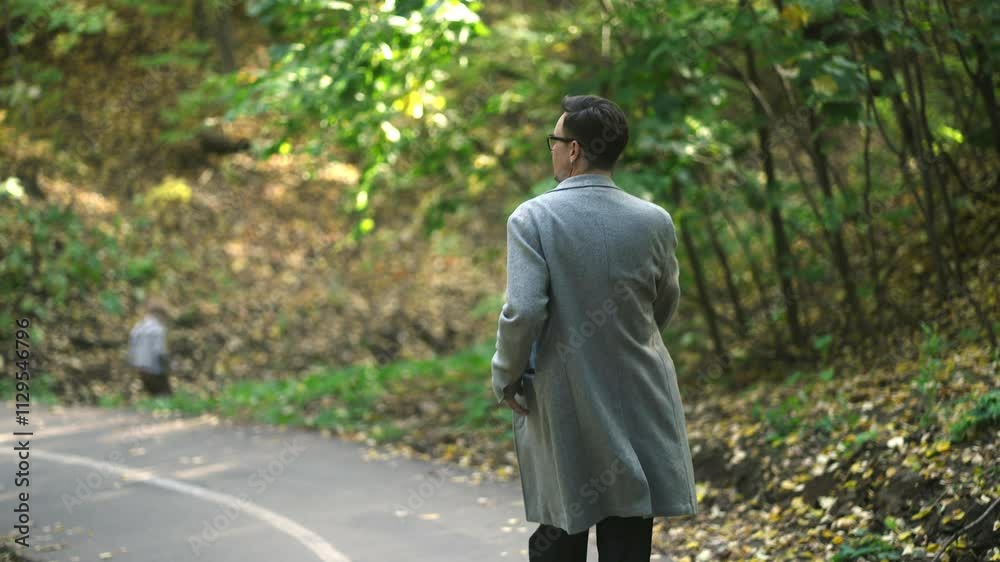 A solitary figure strolls along a serene, winding pathway through a beautiful, lush, autumnal forest landscape A solitary figure strolls along a serene, winding pathway through a beautiful, lush, autumnal forest landscape