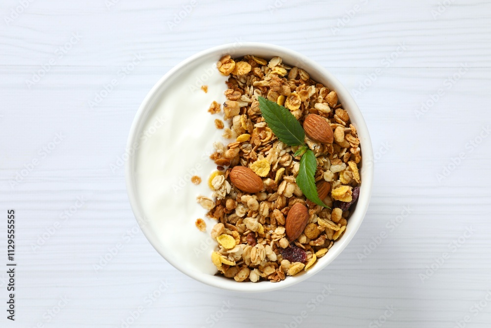 Delicious granola with yogurt on a light background Delicious granola with yogurt on a light background