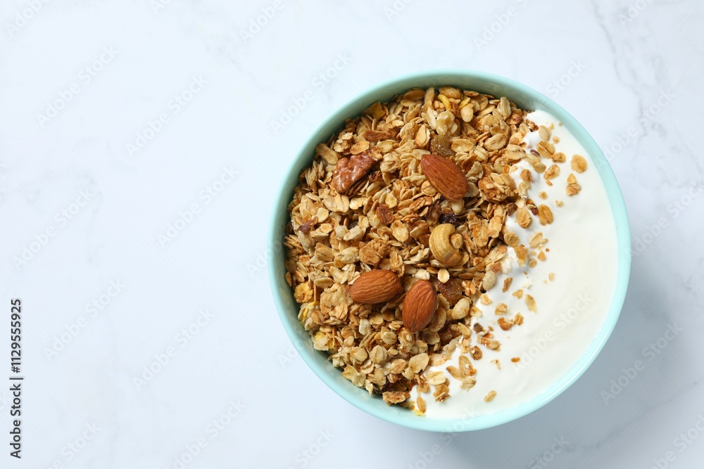 Delicious granola with yogurt on a light background