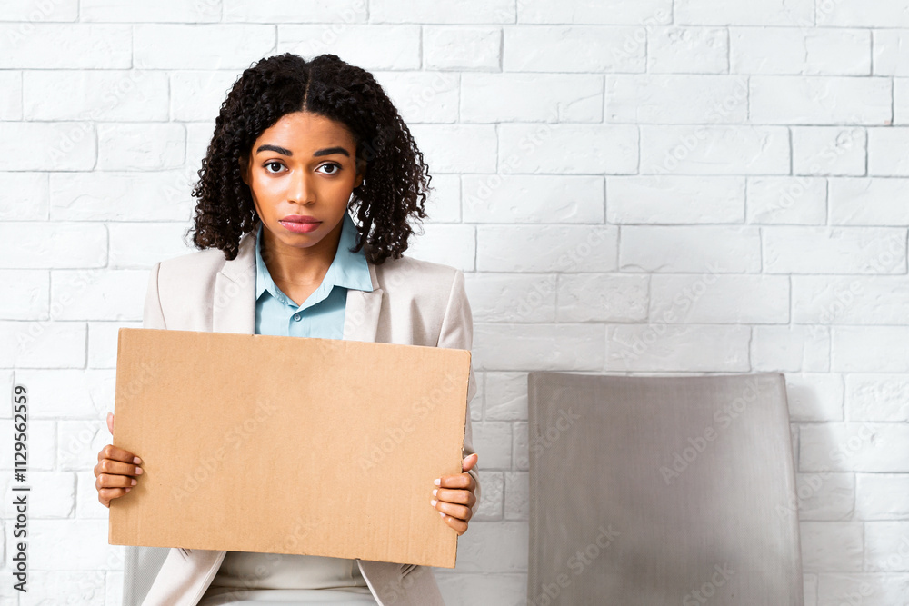 Young black lady with blank sign waiting for employment interview at office lobby, space for design. Panorama Young black lady with blank sign waiting for employment interview at office lobby, space for design. Panorama