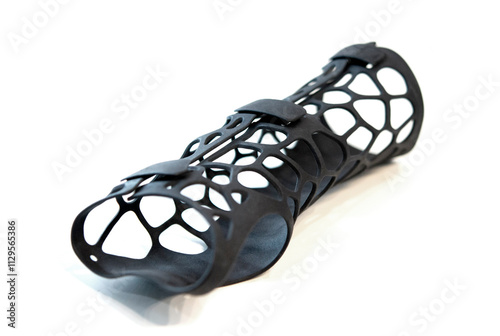 Hand splint corset prosthesis printed on 3D printer from molten black plastic powder isolated on white background. Medical orthosis fixator overlay created on 3D printer. 3D printing technologies