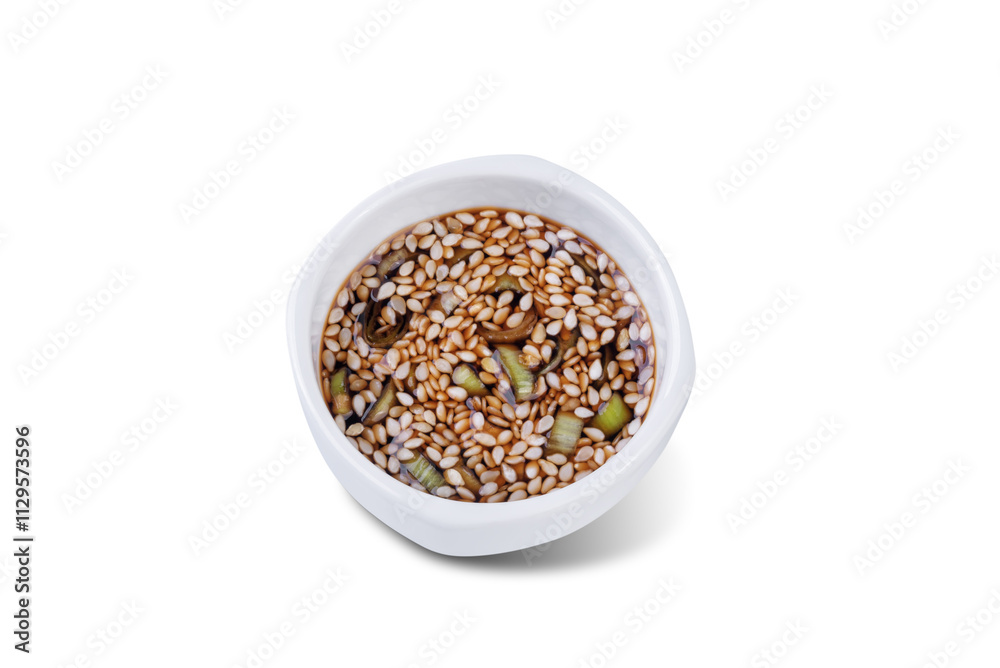 Spicy sesame seeds scallion soy sauce in a white bowl on a white isolated background Spicy sesame seeds scallion soy sauce in a white bowl on a white isolated background