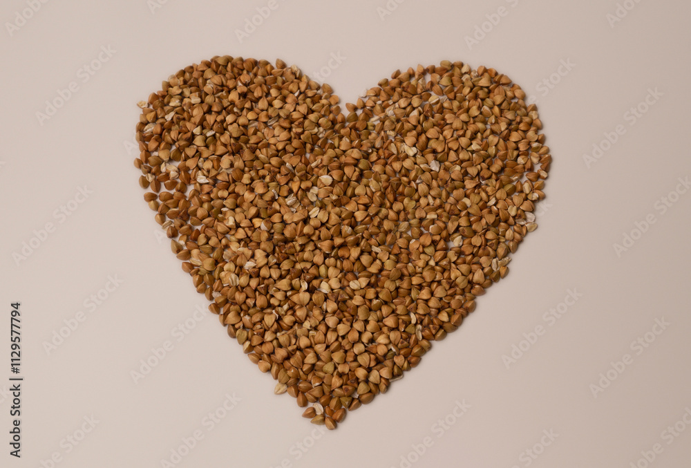 A heart crafted from buckwheat rests on a pristine white background A heart crafted from buckwheat rests on a pristine white background