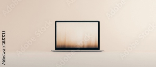 Laptop computer sitting on a plain white surface. the laptop is in the center of the image and is facing towards the right side of the frame.