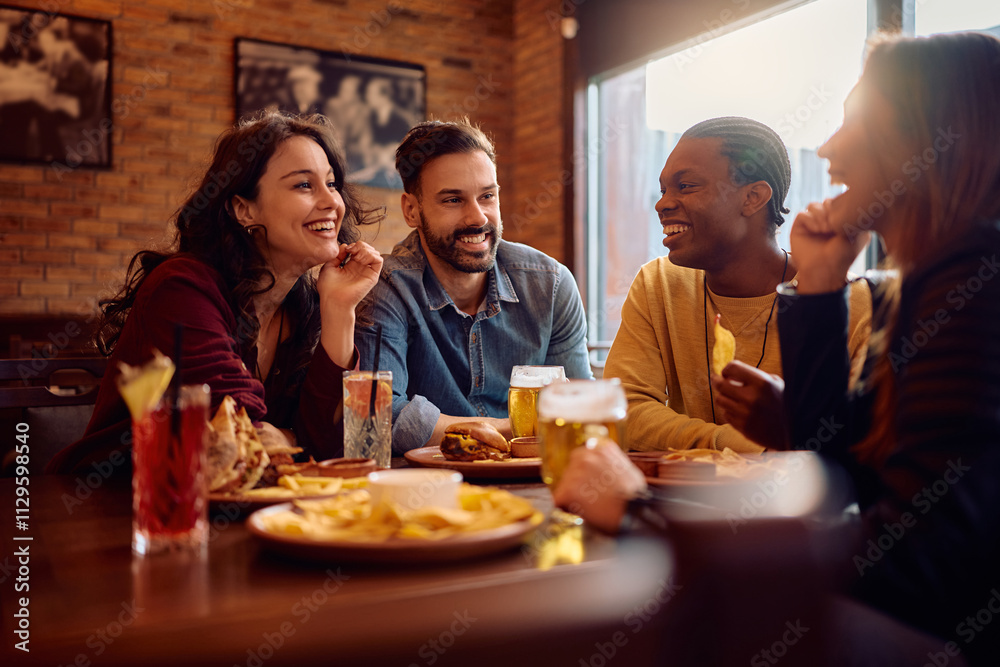 Multiracial group of happy friends talking while sitting in pub. Multiracial group of happy friends talking while sitting in pub.