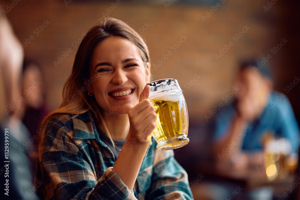 Young happy woman enjoying in a glass of beer in pub. Young happy woman enjoying in a glass of beer in pub.