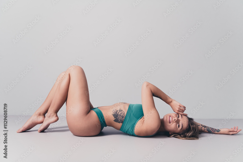 Young woman with natural beauty posing in stylish underwear in a white studio setting, showcasing her slim figure and confident Young woman with natural beauty posing in stylish underwear in a white studio setting, showcasing her slim figure and confident