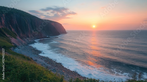 Sunrise illuminating rugged cliffs and atlantic ocean on cape breton island, nova scotia, canada