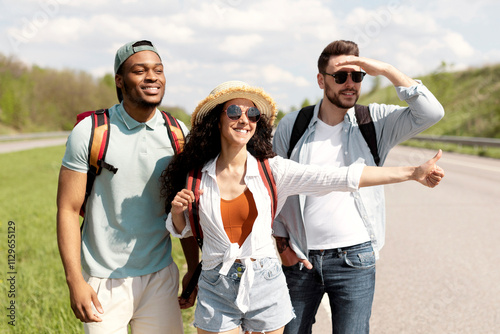 Photography Happy young multiracial friends standing on highway, showing thumb up gesture, hitchhiking for car, going on journey together