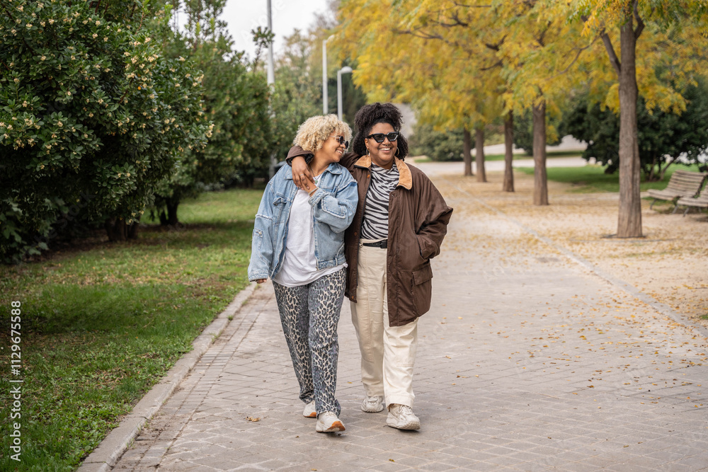 Loving lesbian couple enjoying a leisurely walk in a park Loving lesbian couple enjoying a leisurely walk in a park