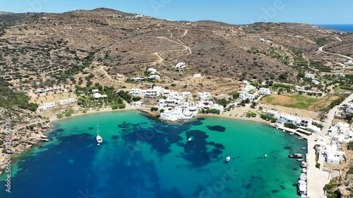 Aerial drone cinematic video of famous and picturesque seaside fishing village and beach of Faros, featuring beaches of Fasolou and Vlycho, Sifnos island, Cyclades, Greece photo