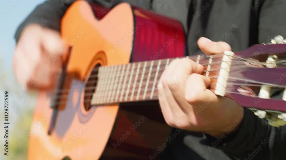 Hands Of A Guitar Playing Musician Having Fun Outside In The Park