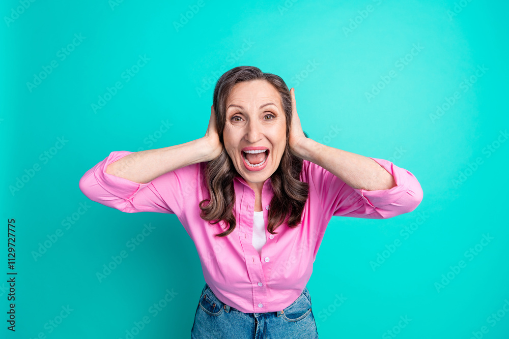 Photo of irritated annoyed lady dressed pink shirt arms close ears empty space isolated turquoise color background Photo of irritated annoyed lady dressed pink shirt arms close ears empty space isolated turquoise color background