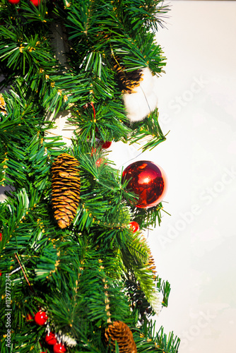 a Christmas tree branch adorned with colorful ornaments