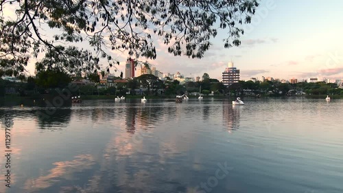 Ipago Lake of Londrina city, Parana, Brazil. A beautiful afternoon at the lake with some pedal boats on the water.