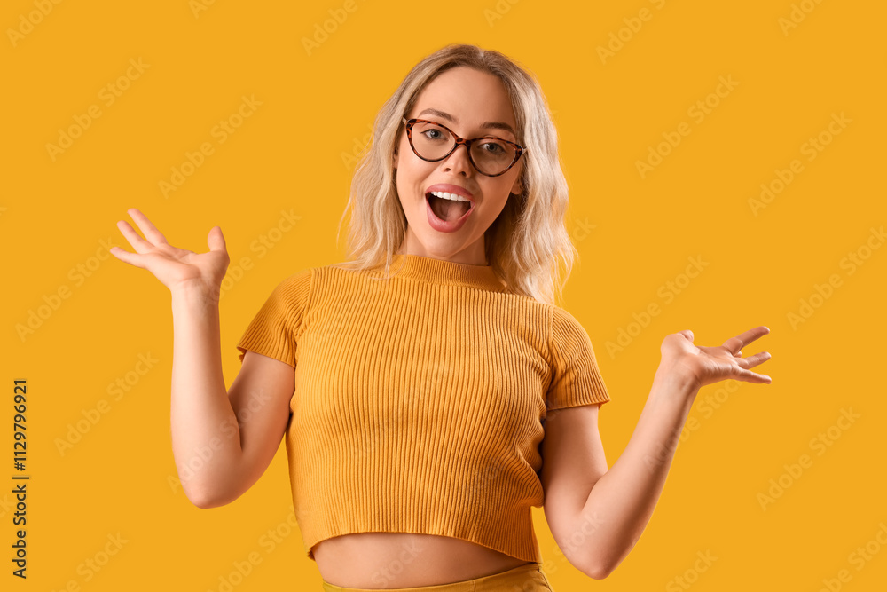 Happy young woman in stylish eyeglasses on orange background Happy young woman in stylish eyeglasses on orange background