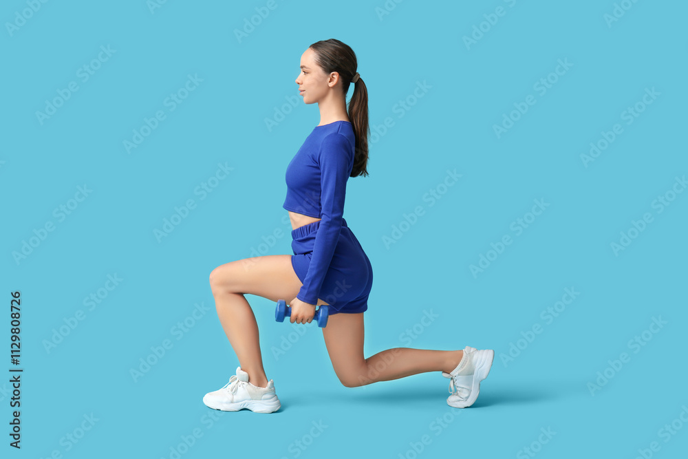 Young female trainer doing fitness exercise on blue background Young female trainer doing fitness exercise on blue background